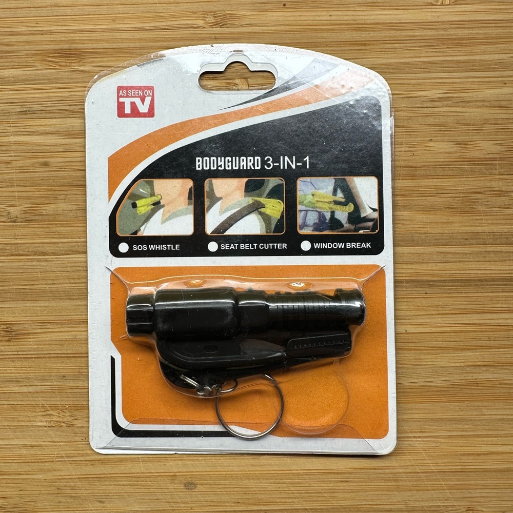 SOS whistle , seat belt cutter, and window break key chain .